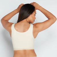 Model wears Comfit Collection Crop Top in NOVELLE PEACH. On body back view