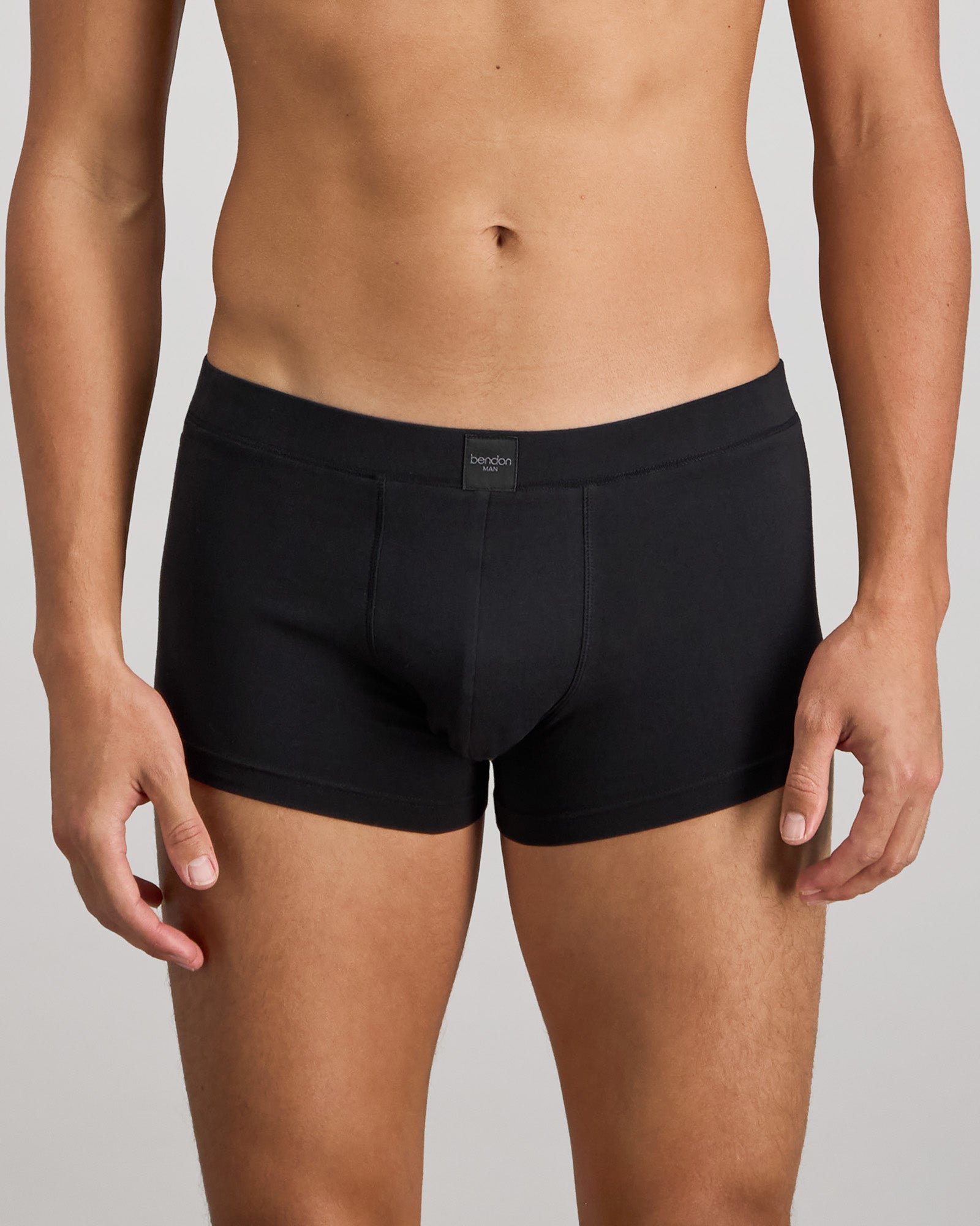 Model wears High Tech Cotton Mens Trunk in BLACK. On body front view