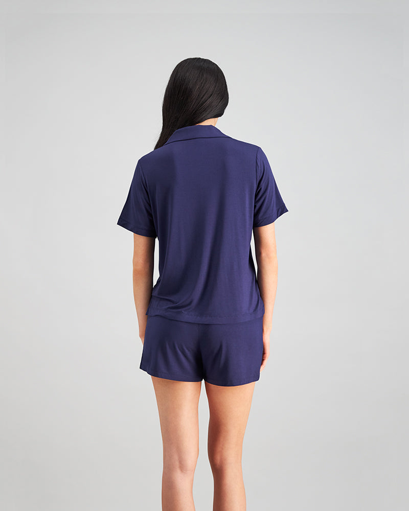 Model wears Belle Bamboo Short PJ in EVENING BLUE. On body back view