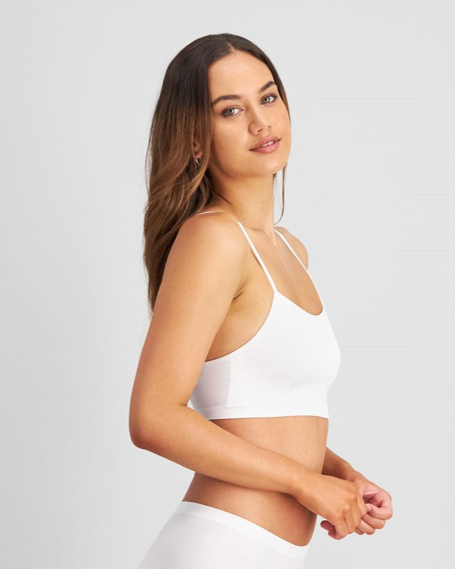 Model wears Simply Seamless Crop Top in WHITE. On body side view