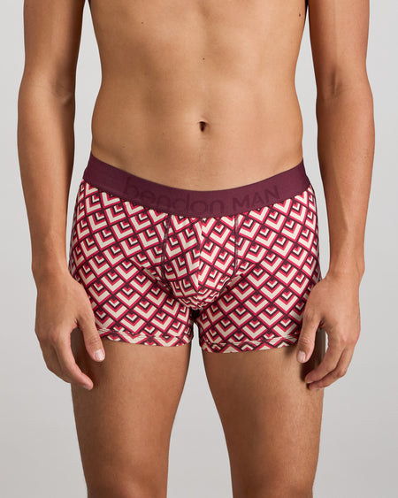 Model wears Retros Print Mens Trunk in ART TILE PRINT. On body front view