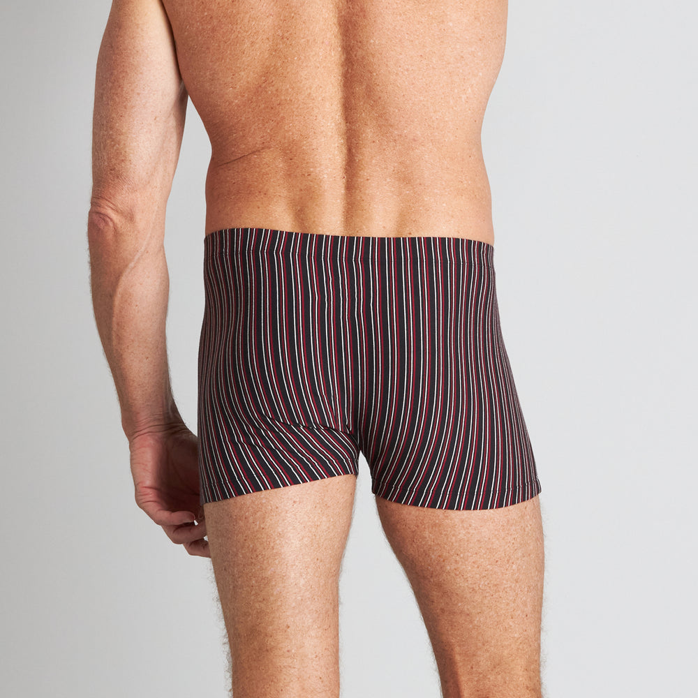 Model wears Cotton Stretch Mens Trunk in BLACK/RHUBARB STRIPE. On body back view