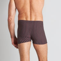 Model wears Cotton Stretch Mens Trunk in BLACK/RHUBARB STRIPE. On body back view