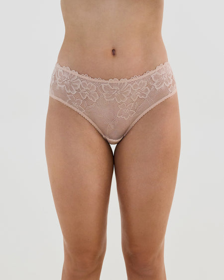 Model wears Lacey Brazilian in LATTE. On body front view