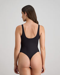 Model wears Extra-Ordinary Bodysuit in BLACK. On body back view