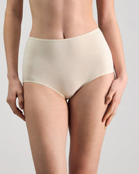 Model wears Freestyle Full Brief in CHAMPAGNE. On body front view