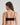 Model wears Extra-Ordinary Crop Top in BLACK. On body back view