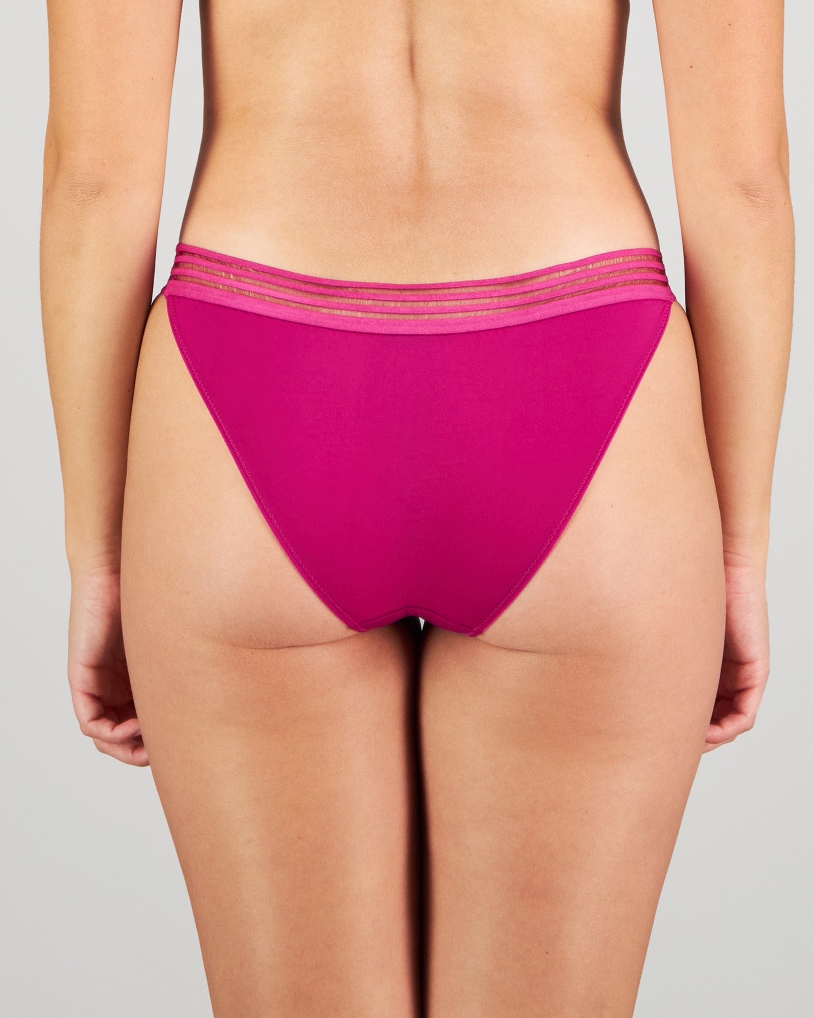 Model wears Stripe Elastic & Papertouch Tanga in FANTASY FUCHSIA. On body back view