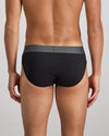 Model wears Cotton Low-Rise Mens Brief in BLACK. On body back view