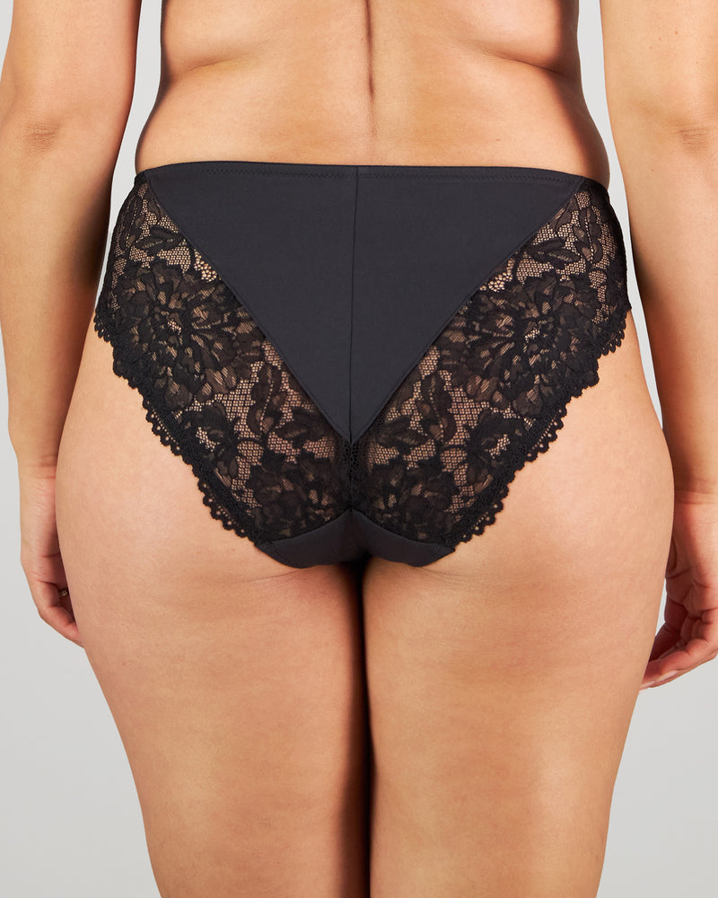 Model wears Laurel High Cut Brief in BLACK. On body back view