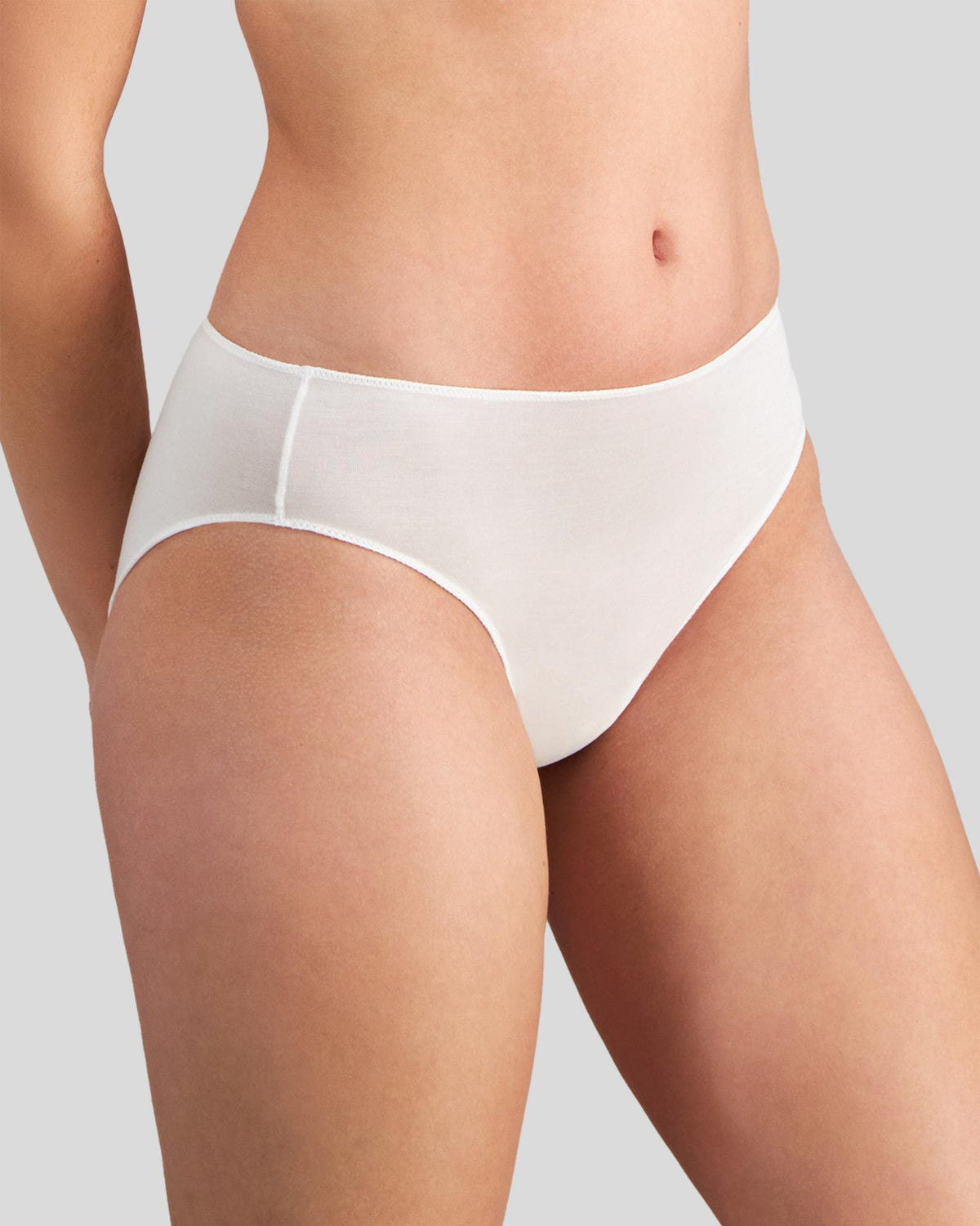 Model wears Au Naturel High Cut Brief in WHITE. On body side view