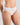 Model wears Au Naturel High Cut Brief in WHITE. On body side view