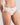 Model wears Au Naturel High Cut Brief in WHITE. On body side view