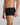 Model wears High Tech Cotton Mens Trunk in BLACK. On body side view