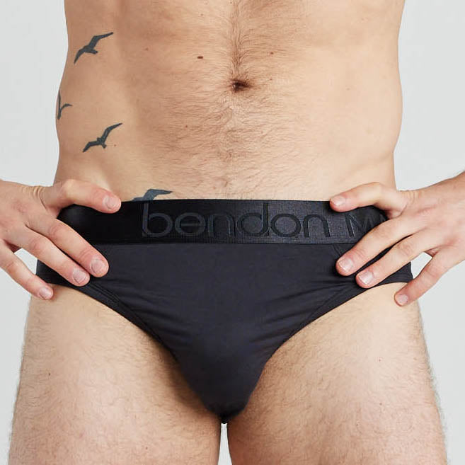 Model wears Bamboo Mens Brief in BLACK. On body front view