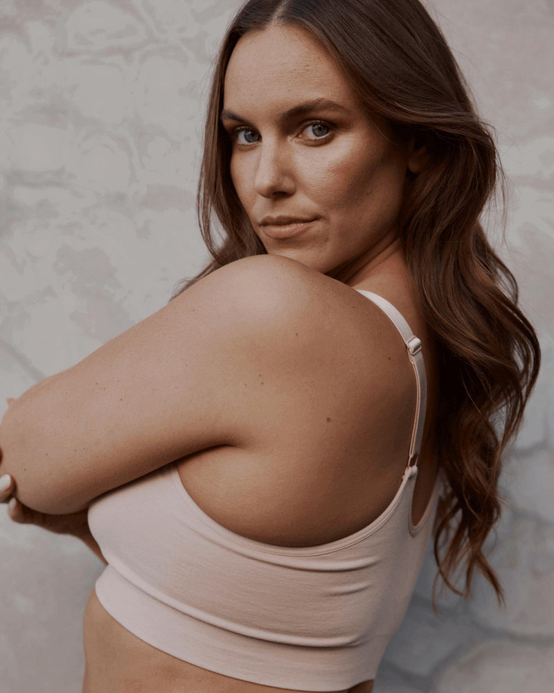 Model wears Bendon Restore Wire Free Front Opening Bra in LATTE. On body side view