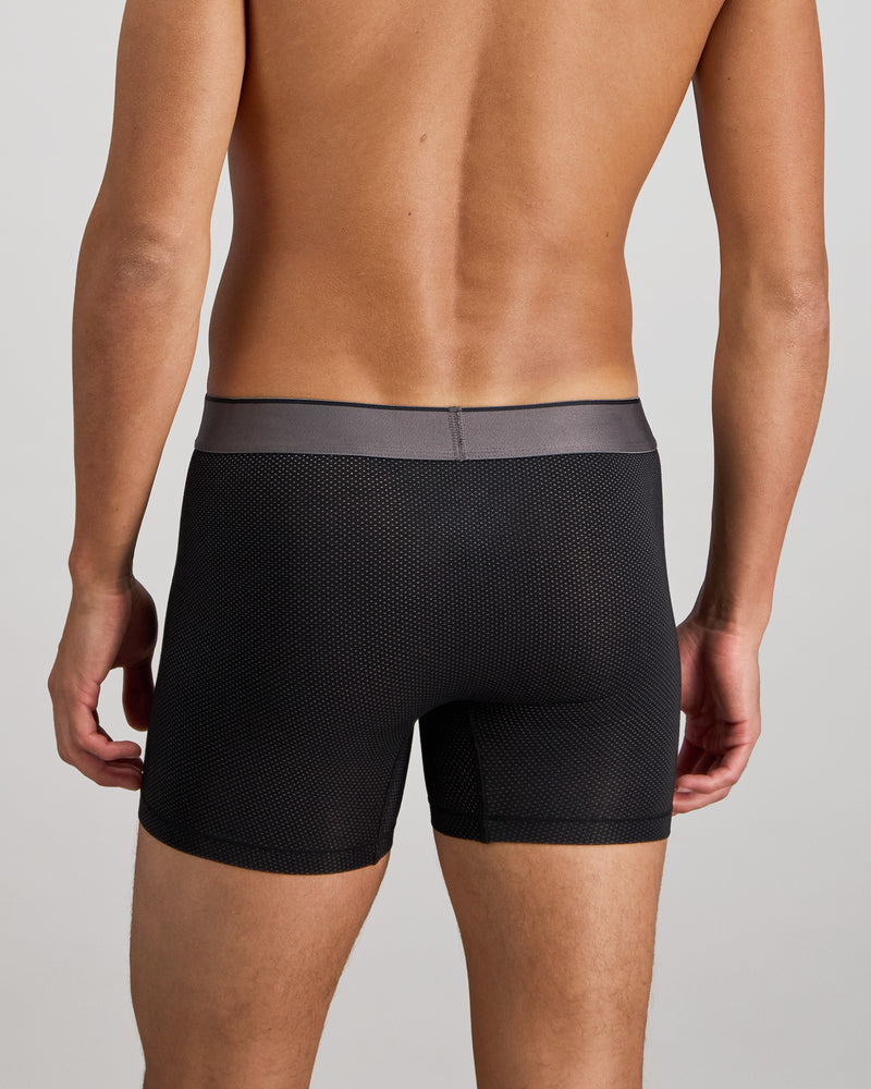 Model wears Everyday Active Mens Long Trunk in BLACK. On body back view