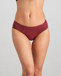 Model wears Body Cotton Bikini in OXBLOOD RED. On body front view