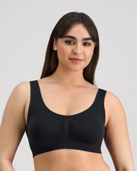 Model wears Bendon Essentials Crop Top in BLACK. On body front view