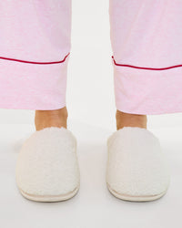 Model wears Teddy Slippers in CREAM. On body side view