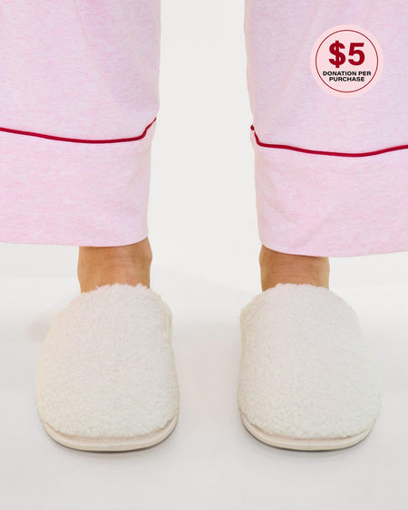 Model wears Teddy Slippers in CREAM. On body side view