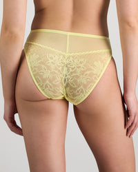 Model wears Elevate High Cut Brief in LEMON MERINGUE. On body back view