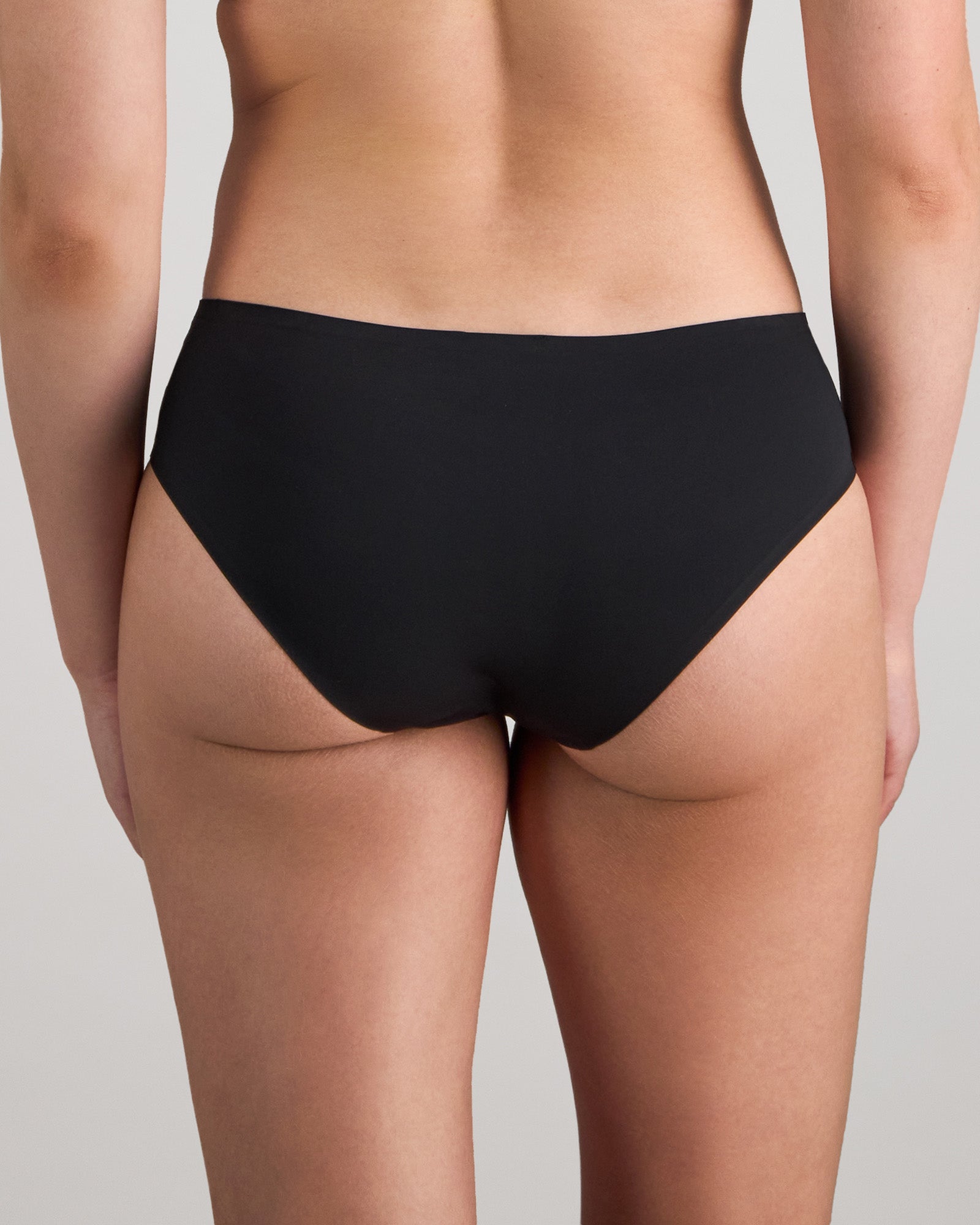 Model wears My Fit Smooth Brazilian in BLACK. On body back view