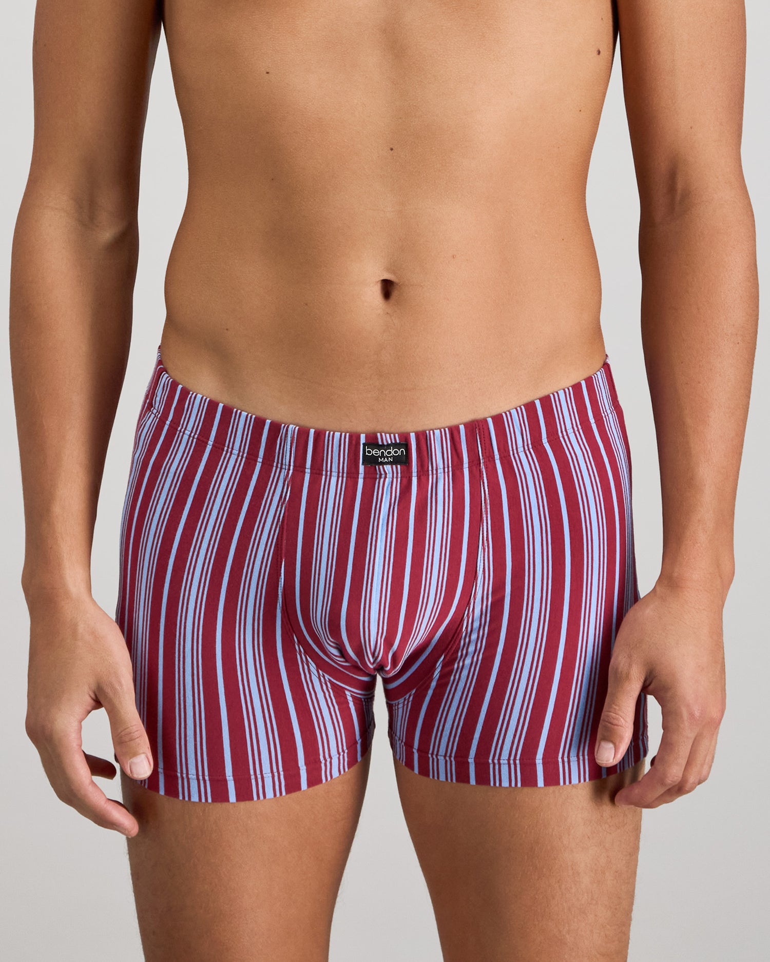 Model wears Cotton Stretch Mens Trunk in TIBETAN RED STRIPE. On body front view