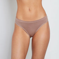 Model wears Seamless Thong in MOCHA. On body front view