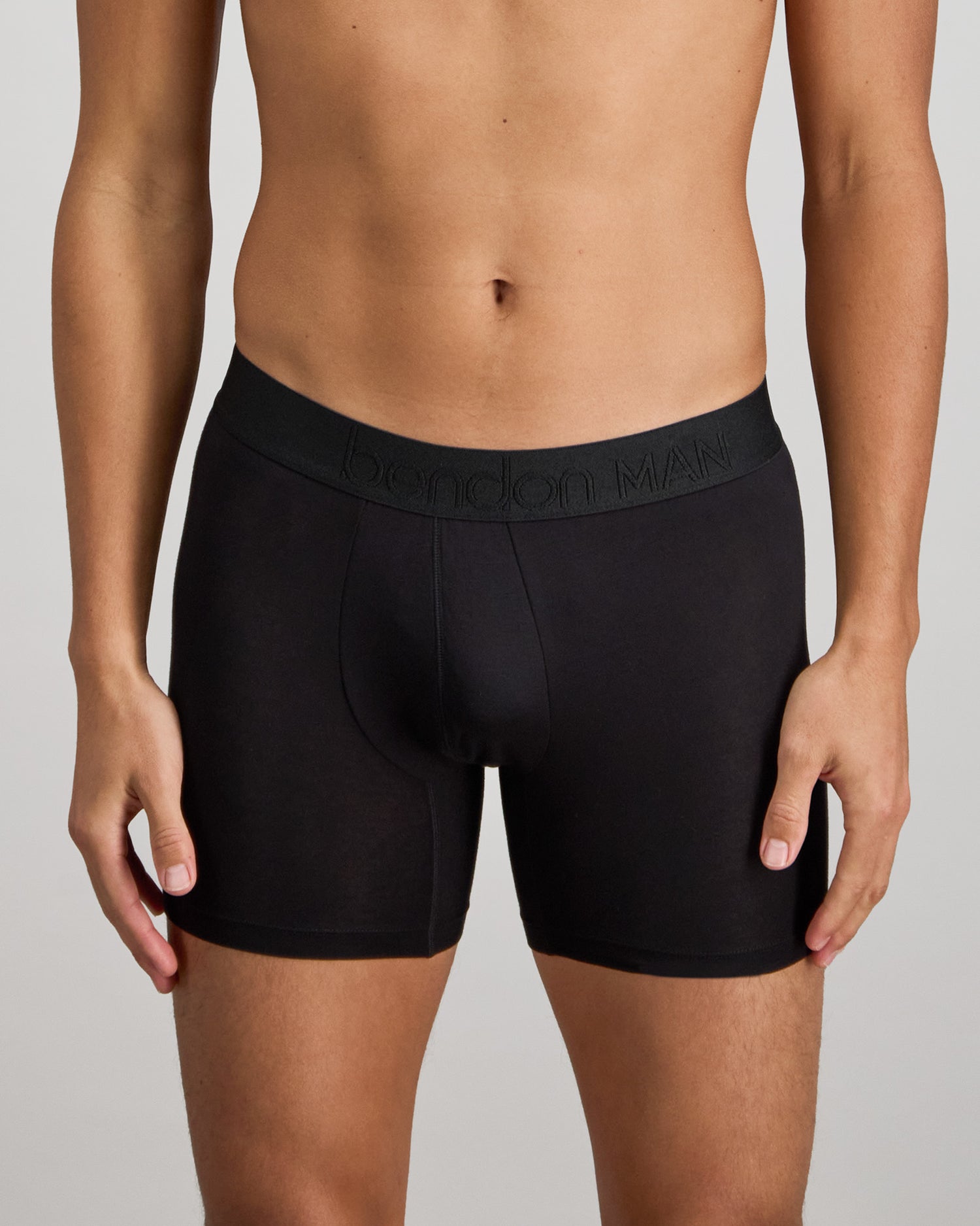 Model wears Bamboo Mens Trunk in BLACK. On body front view