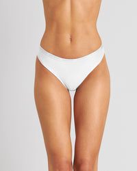 Model wears Body Cotton Thong in WHITE. On body front view