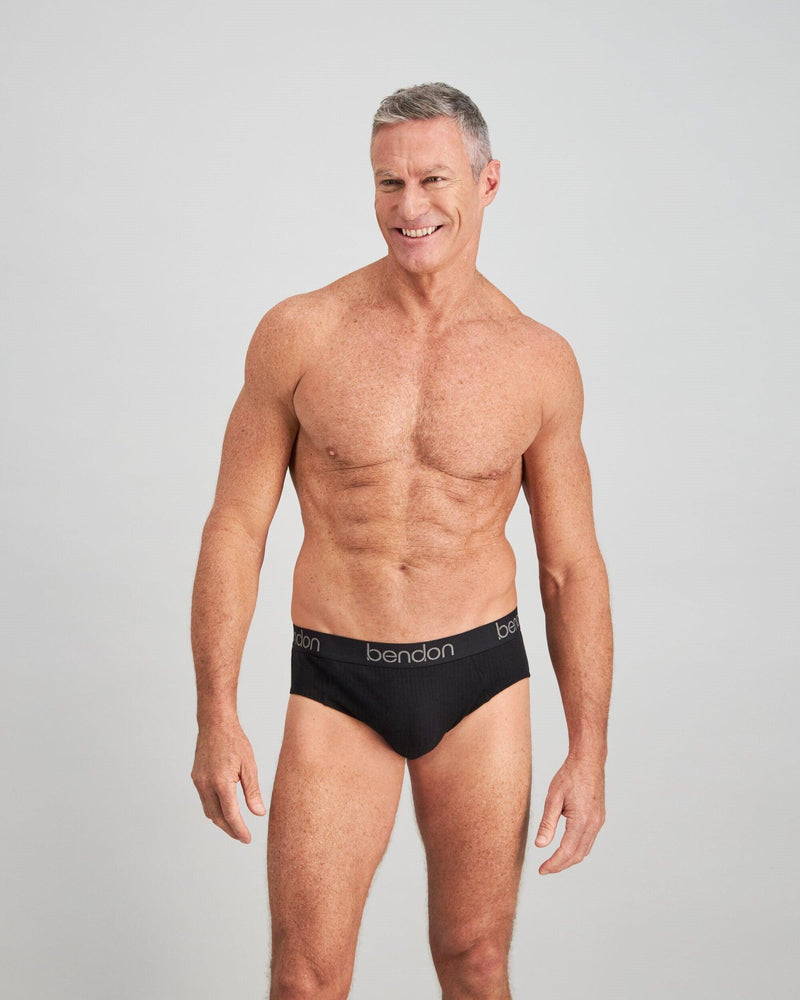 Model wears Cotton Texture Mens Brief in BLACK. On body front view