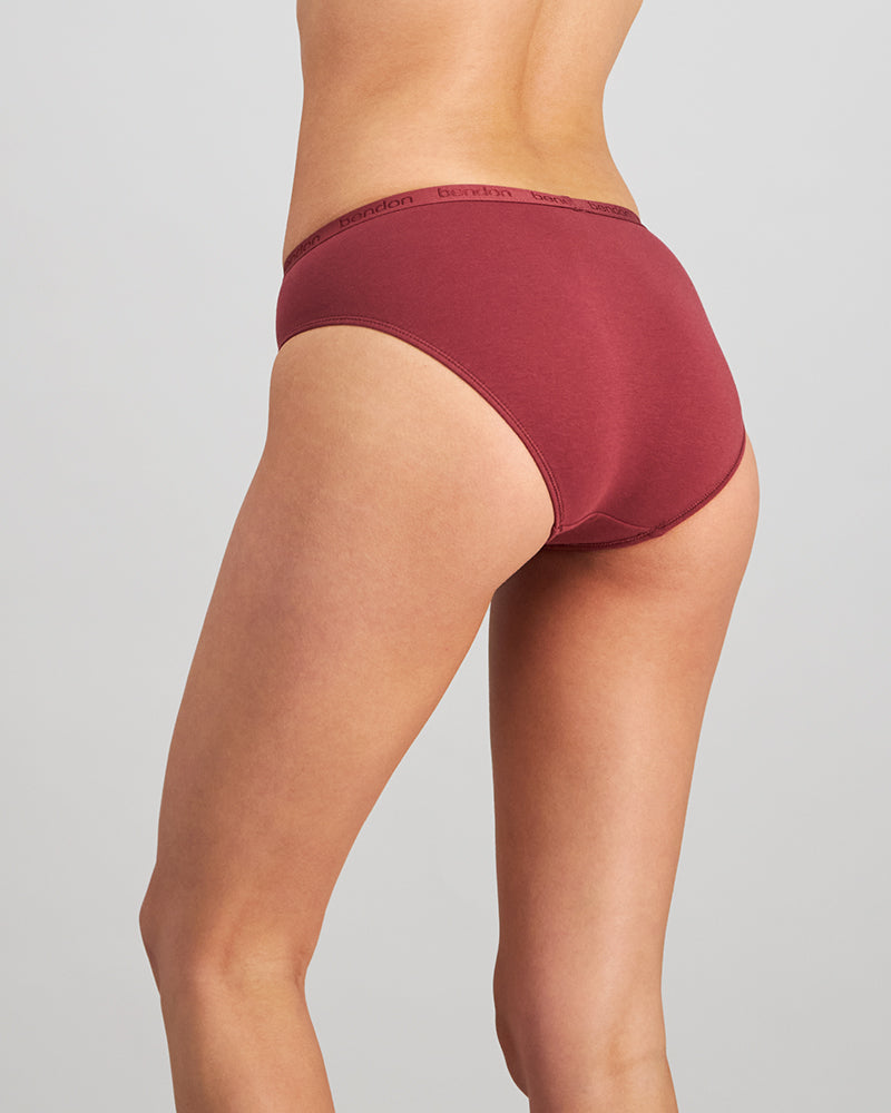 Model wears Body Cotton Bikini in OXBLOOD RED. On body back view