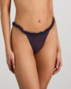 Model wears Wrapped In Stardust Thong in PURPLE VELVET. On body side view