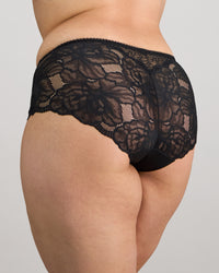 Model wears Midnight Express Full Brief in BLACK. On body front view