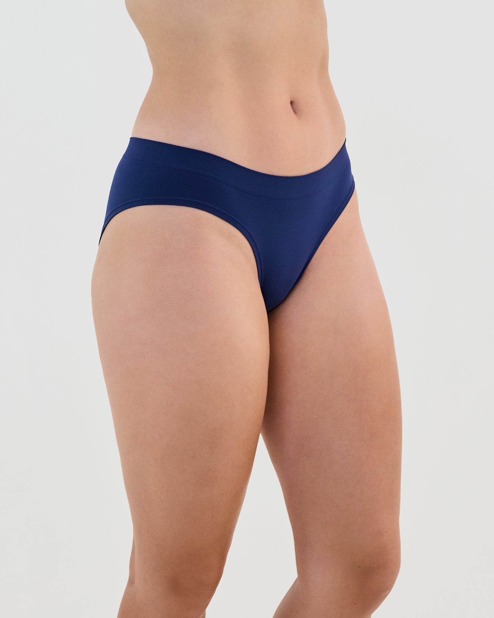 Model wears Seamless Soft Bikini in Medieval Blue. On body side view