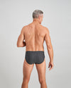 Model wears Cotton Stretch Mens Brief in CHAR BLACK. On body back view