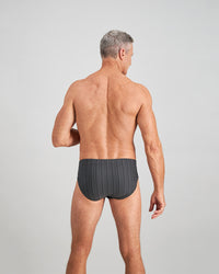 Model wears Cotton Stretch Mens Brief in CHAR BLACK. On body back view