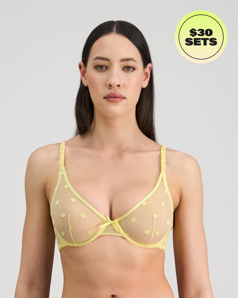 Model wears Sunlit Underwire Bra in LEMON MERINGUE. On body front view