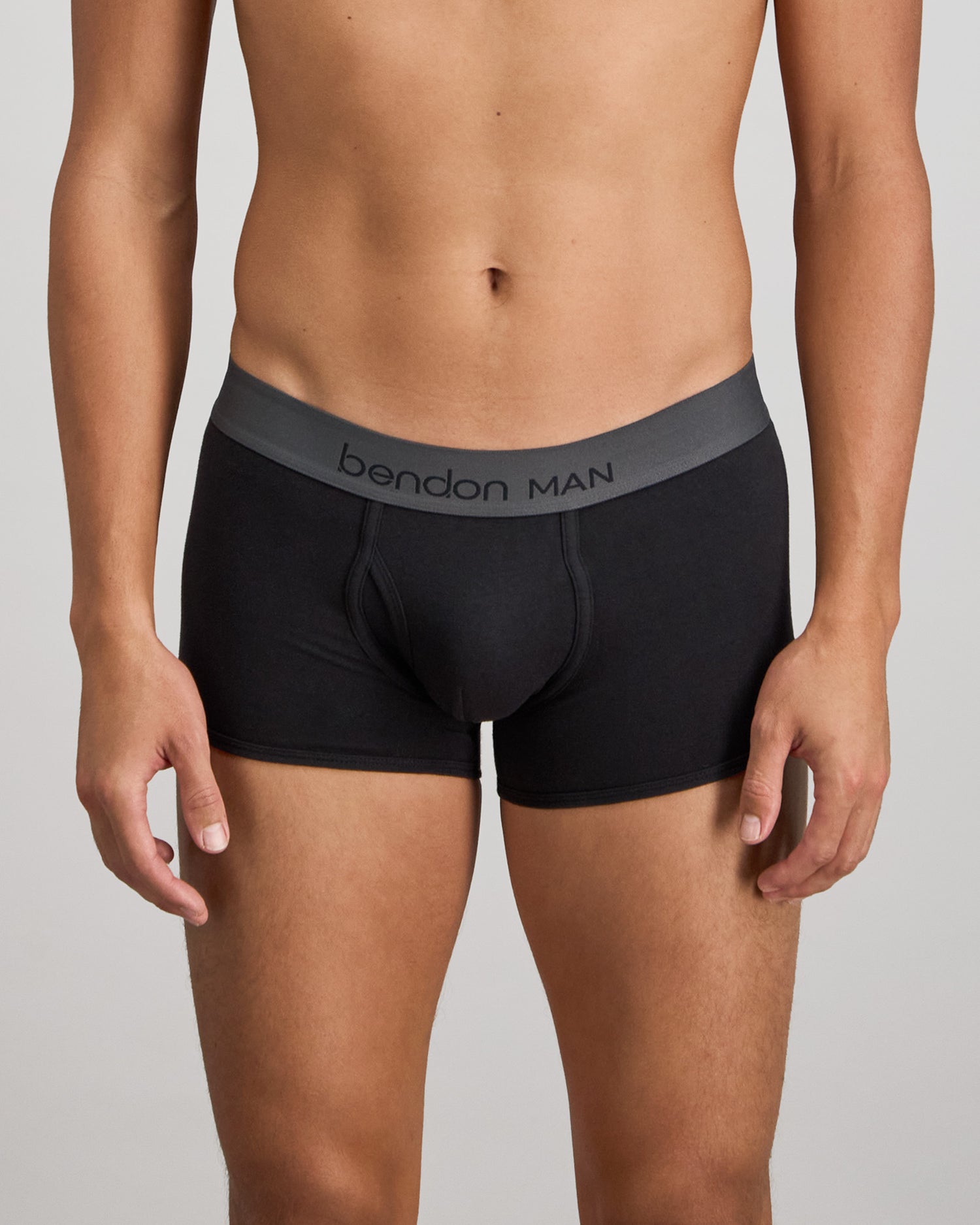 Model wears Cotton Low-Rise Mens Trunk in BLACK. On body front view