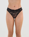Model wears All Lacey Thong in BLACK. On body front view