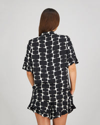 Model wears Audacious Dreams Short PJ in MINIMALIST PRINT. On body back view