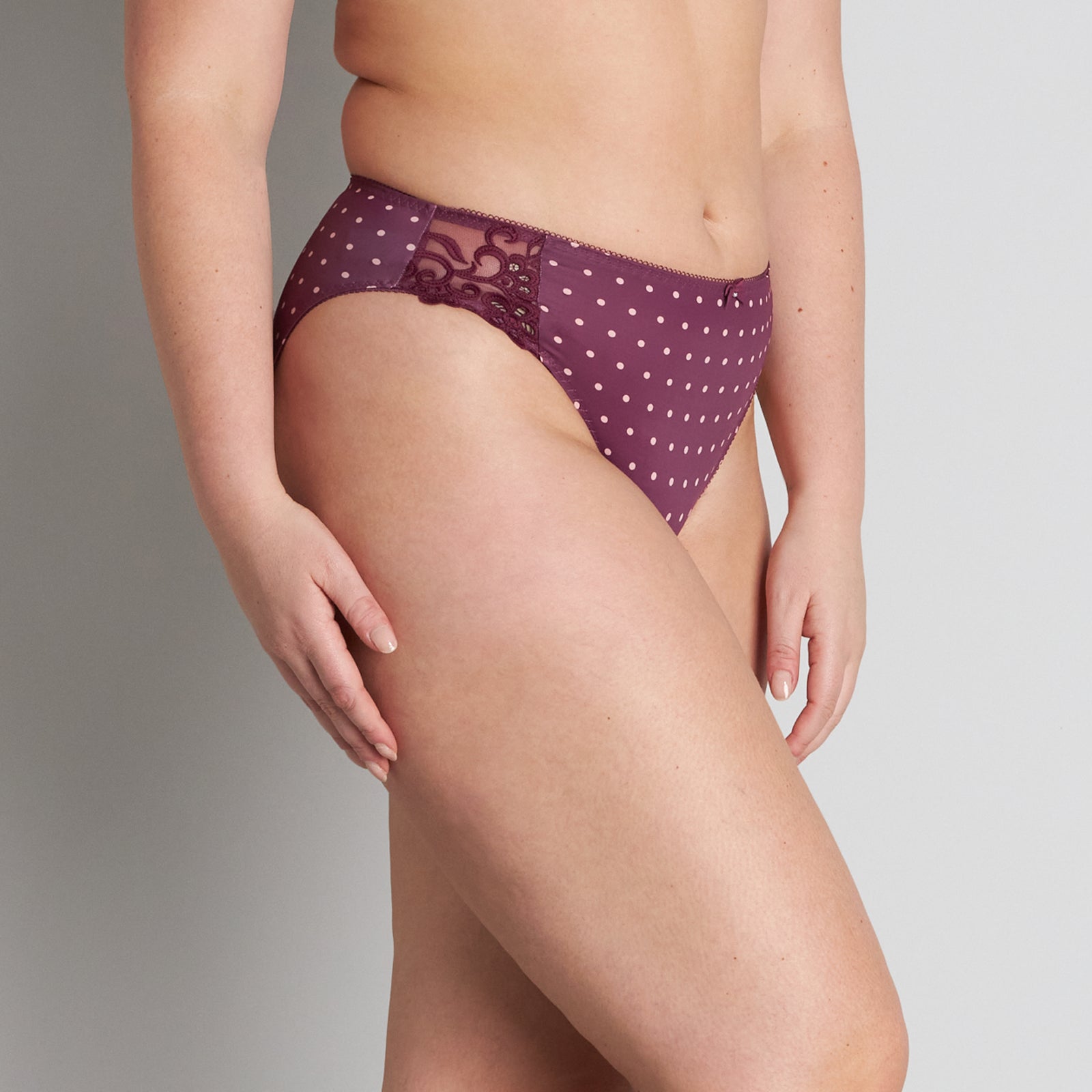 Model wears Rose Dot High Cut Brief in GRAPE WINE/ROSE CLOUD. On body side view