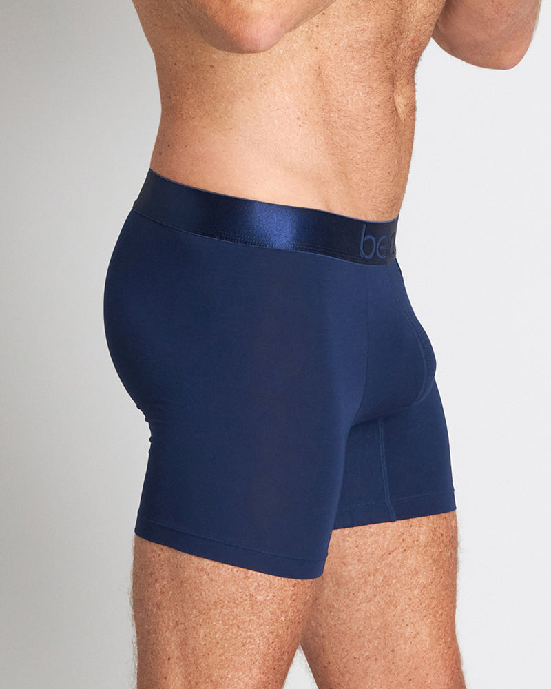 Model wears Bamboo Mens Trunk in Medieval Blue. On body side view
