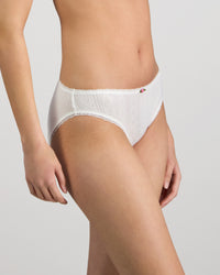 Model wears Body Cocoon Bikini in WHITE. On body side view