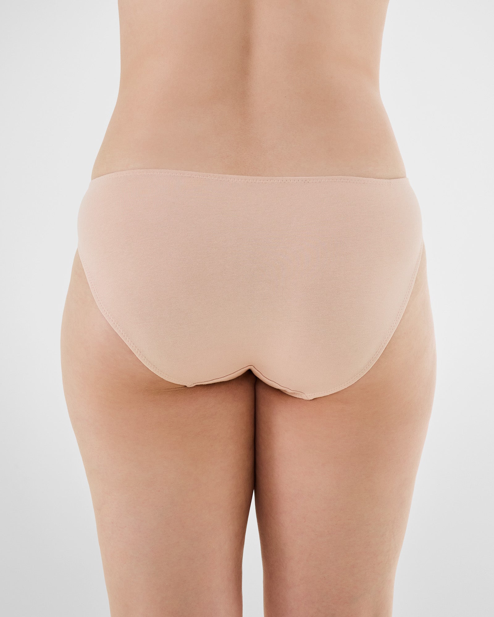 Model wears Embrace Bikini in LATTE. On body back view