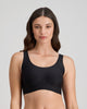 Model wears Comfit Collection Crop Top in BLACK. On body front view