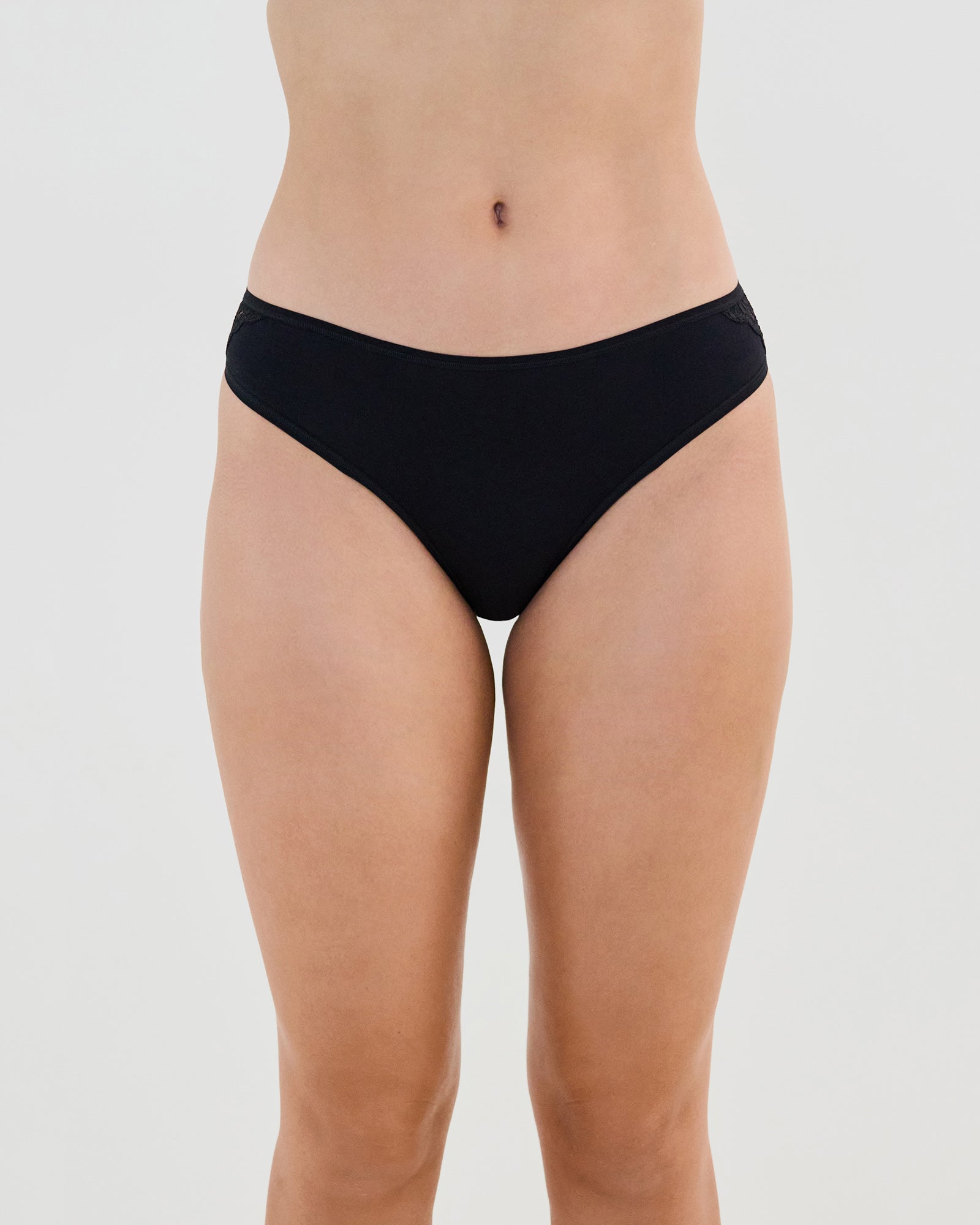 Model wears Cotton And Lace Bikini in BLACK. On body front view