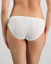 Model wears Body Cocoon Bikini in WHITE. On body back view