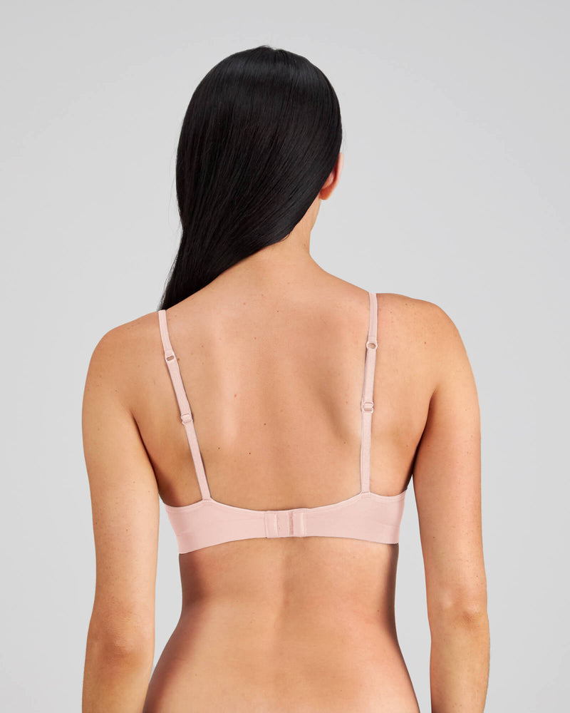 Model wears Simply Seamless Contour Bra in SILVER PINK. On body back view